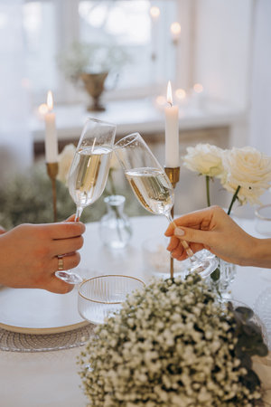 Romantic couple having dinner in an elegant restaurant toasting each other with flutes of champagneの写真素材