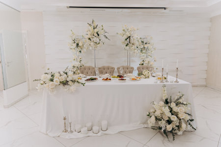 Elegant wedding reception setup with luxurious floral arrangements and chic table decorの写真素材