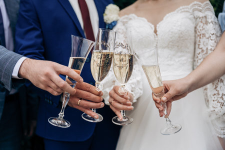 Wedding toast celebration with champagne glasses. Elegant bride and groom momentの写真素材