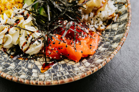 Delicious poke bowl with fresh salmon, mango, rice, seaweed - perfect for healthy and colorful mealsの写真素材