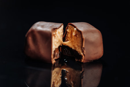 Decadent chocolate candy with gooey caramel filling, perfect for confectionery and dessert themesの写真素材