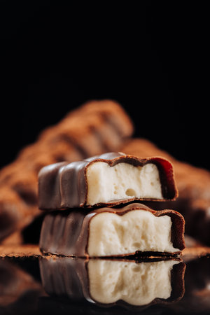Chocolate bar with creamy filling on dark background, ideal for dessert and confectionery conceptsの写真素材