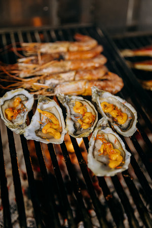 Grilled oysters with cheese on BBQ grill, ideal for restaurant menus, seafood cuisineの写真素材