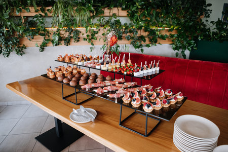 Assorted gourmet appetizers and desserts on display, luxury events, catering, and celebrationsの写真素材