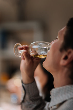 Vinnitsa, Ukraine - September 21, 2024: Man enjoying premium whisky tasting experience at an event
