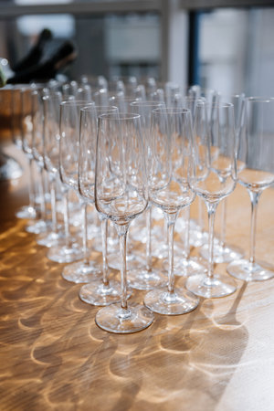 Elegant set of empty crystal wine glasses arranged for event or celebration in a bright settingの写真素材