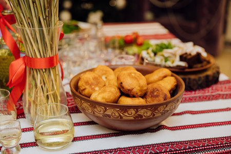 Traditional Ukrainian celebration table with homemade fried pastries, decor, and national cuisineの写真素材