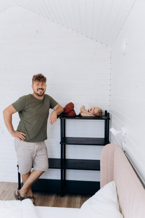 Father and son spending time together in a cozy, modern home interior with minimalist design