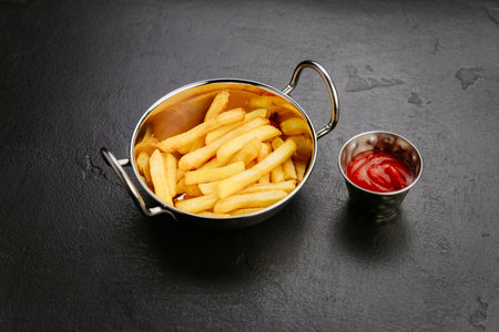 Crispy golden French fries served with ketchup, the perfect side dish or snack for any occasion