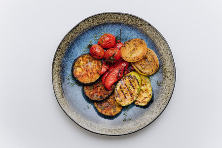 Grilled vegetables platter with zucchini, eggplant, peppers, and tomatoes for a healthy dishの写真素材