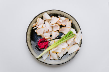 Traditional sliced salo with green onions and beet horseradish dip for an authentic Ukrainian snackの写真素材
