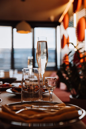 Elegant glass of champagne on festive table setting, ready for refined celebration or dining eventの写真素材