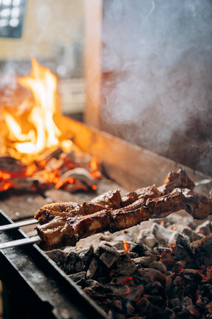 Grilled meat skewers roasting over charcoal flames, capturing the essence of BBQ perfectionの写真素材
