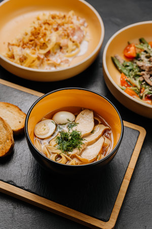 A flavorful trio of pasta, salad, and soup with bread, perfect for a balanced and satisfying meal