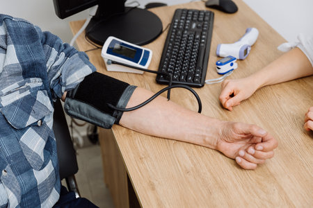 Patient blood pressure check in a clinic setting with digital monitor and medical devices