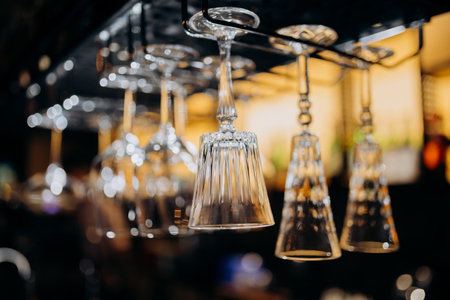 Elegant hanging glassware in a modern bar setting, perfect for upscale nightlife and fine diningの写真素材