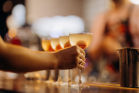 Elegant cocktails served in coupe glasses, perfect for a chic bar setting or special celebrationの写真素材