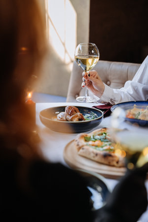 Elegant dining scene with wine and gourmet dishes, perfect for luxurious lifestyle themesの写真素材
