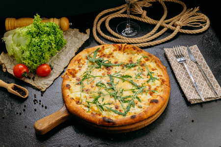 Gourmet four-cheese pizza with arugula, served on a wooden board in a stylish restaurant settingの写真素材