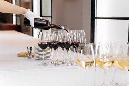 Elegant wine pouring at formal event with white glove serviceの写真素材