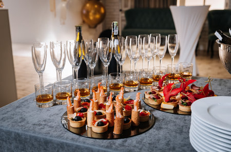 Elegant gourmet appetizers and champagne glasses set for a festive celebrationの写真素材