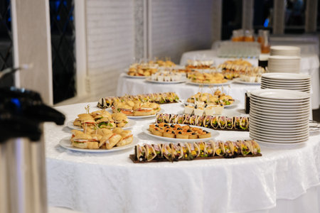 Buffet table with assorted mini sandwiches and appetizers for event catering service