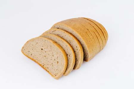 Sliced rye bread loaf isolated on white background, healthy whole grain bakery product