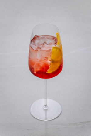 Classic Aperol Spritz with ice and orange slice in elegant glass on light backgroundの写真素材