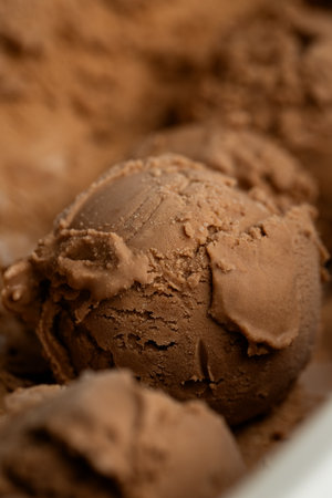 Creamy chocolate ice cream scoops close-up, rich texture and deep brown colorの写真素材