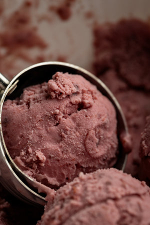Creamy raspberry ice cream scoops in close-up, rich texture and vibrant pink colorの写真素材