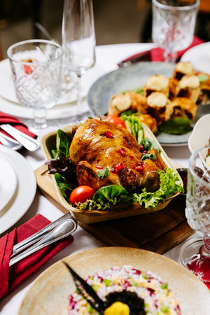 Roasted chicken with pomegranate and vegetables served on festive holiday table