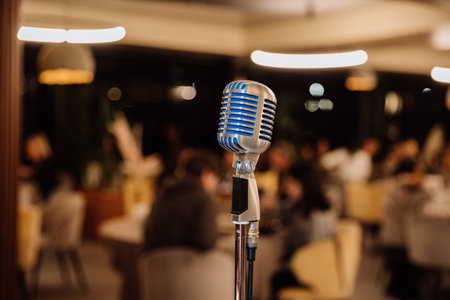 Retro microphone on stage in cozy restaurant, ready for live music, speech or standup showの写真素材