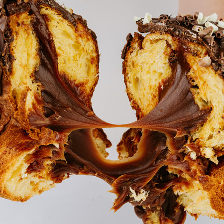 Stretchy chocolate filling inside torn Christmas panettone, indulgent festive dessertの写真素材
