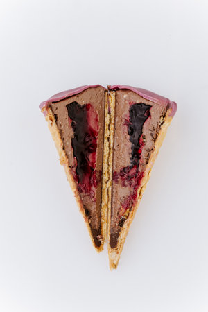 Sliced chocolate berry ice cream with waffle crust and berry sauce filling, macro close-upの写真素材