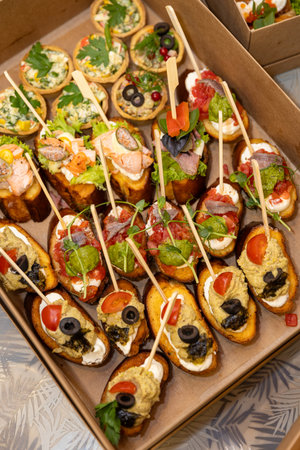 Catering box with assorted canapes and bruschetta for party buffet and deliveryの写真素材
