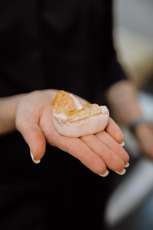 Implant surgical guide on dental model in clinician hand, clinic closeupの写真素材