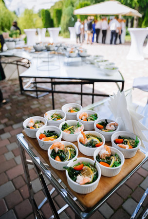 Outdoor catering: mini shrimp seaweed salads in ramekins with lemon, garden receptionの写真素材