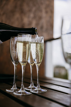 Pouring champagne into flute with sparkling bubbles for celebration toastの写真素材
