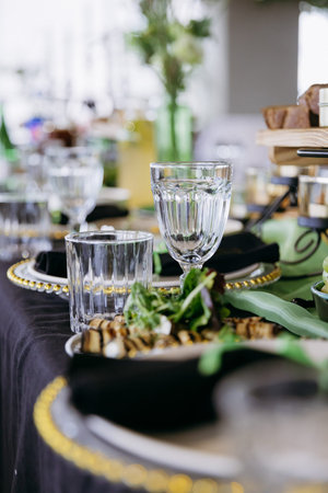 Close up of elegant event table setting with glassware and appetizer