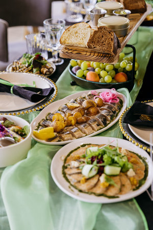 Catering banquet table with elegant place settings, appetizers and fruit