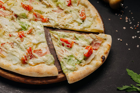 White pizza with chicken cheese lettuce and tomato on rustic dark backgroundの写真素材