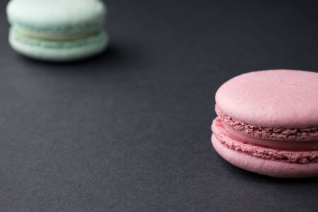 colored sweet macaroons on a black background isolateの写真素材