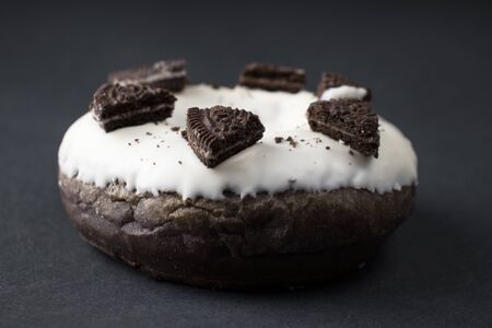 chocolate donut in white glaze closeupの写真素材