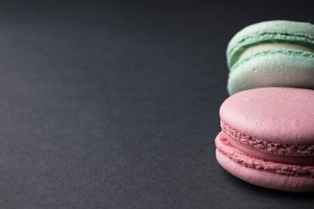 delicate macaroons on a black backgroundの写真素材