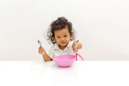Asian Child twenty-two months are eating on their own.の写真素材