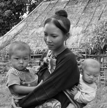 BOKEO,LAO PDR-JULY 21,2011 LANTAEN teen mom carries her kids on  July 21,2011 in Nam chang village, Bokeo province, Lao pdrのeditorial素材