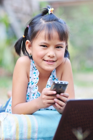 Little asian girl on a cell phoneの写真素材