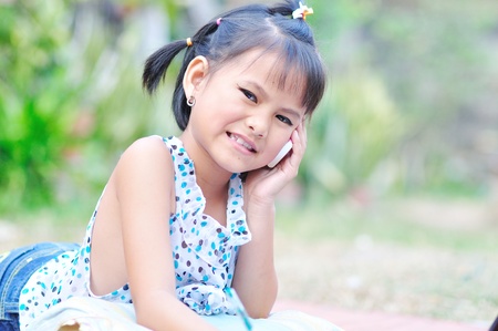 Little asian girl on a cell phoneの写真素材