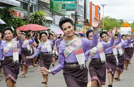UBONRATCHATHANI,  THAILAND - JULY 23 : Unidentified dancers perform traditional Thai-Esan dance on the traditional candle procession festival of Buddha. Local people and tourists happily celebrate together. July 23,2013  in Ubonratchathani, Thailand.のeditorial素材
