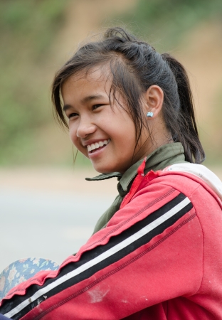 BAN NONGKHAM , VIANGPHOUKHA, LUANGNAMTHA , LAO P D R - MAY 31   Unidentified Khmu ethnic girl 15 years old smiles on the R3A route on May 31,2013 in Viangphoukha,Luangn amtha,Lao pdrのeditorial素材